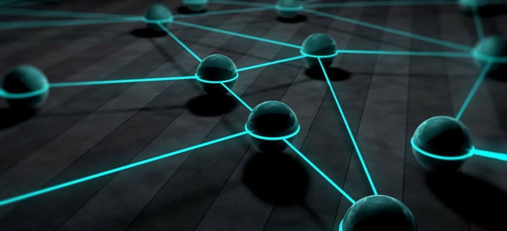 Réseau de sphères connectées par des lignes lumineuses turquoise sur une surface sombre, symbolisant la connectivité et les réseaux numériques.